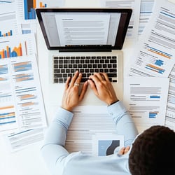 a person working with documents and files on a laptop-3